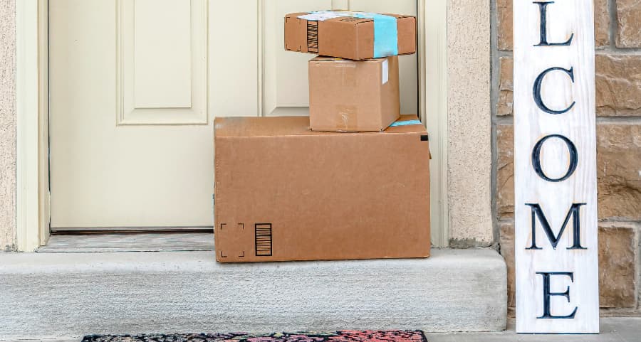 Deliveries on the front porch of a house with a welcome sign in Manhattan